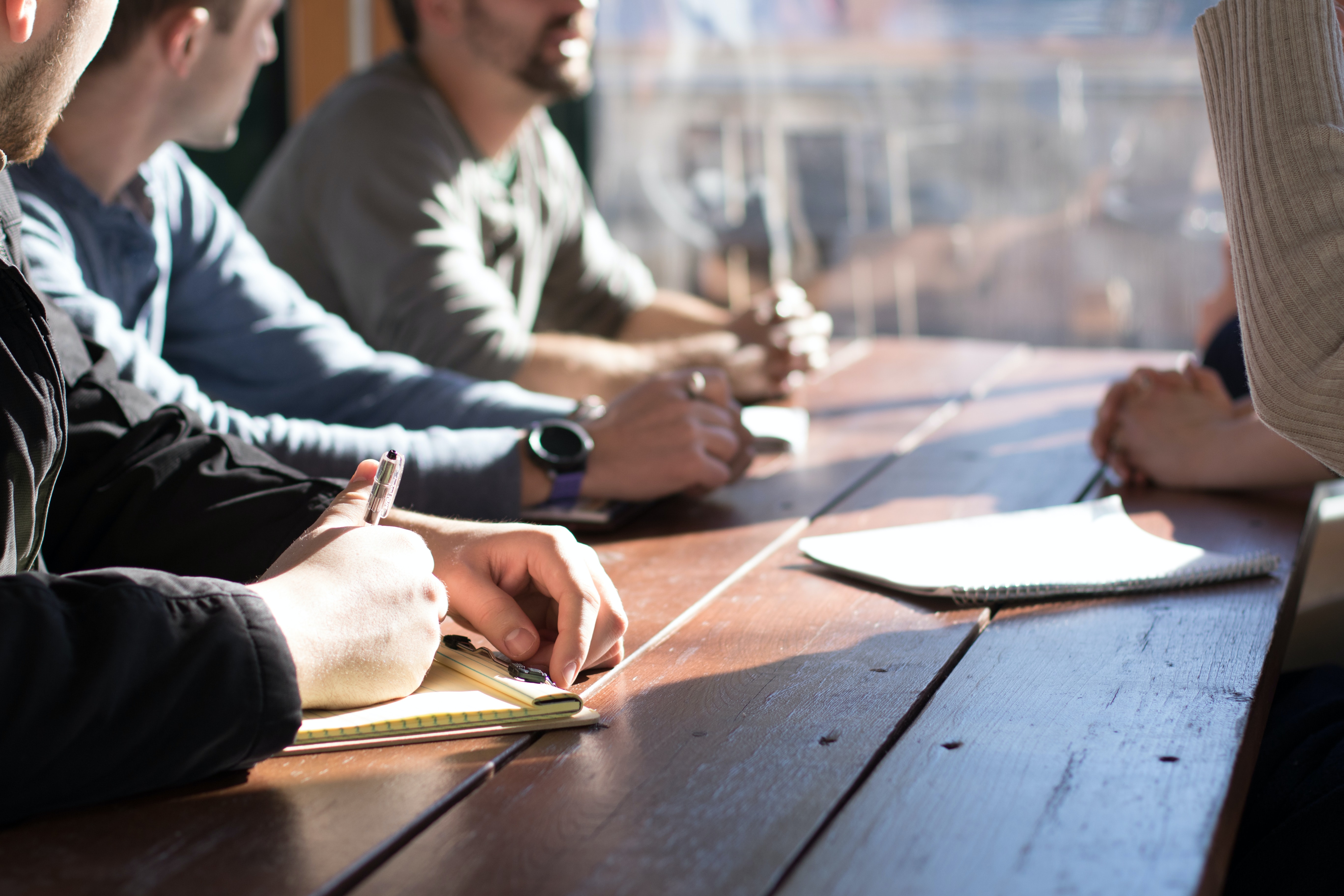 people sitting at a table in a conversation